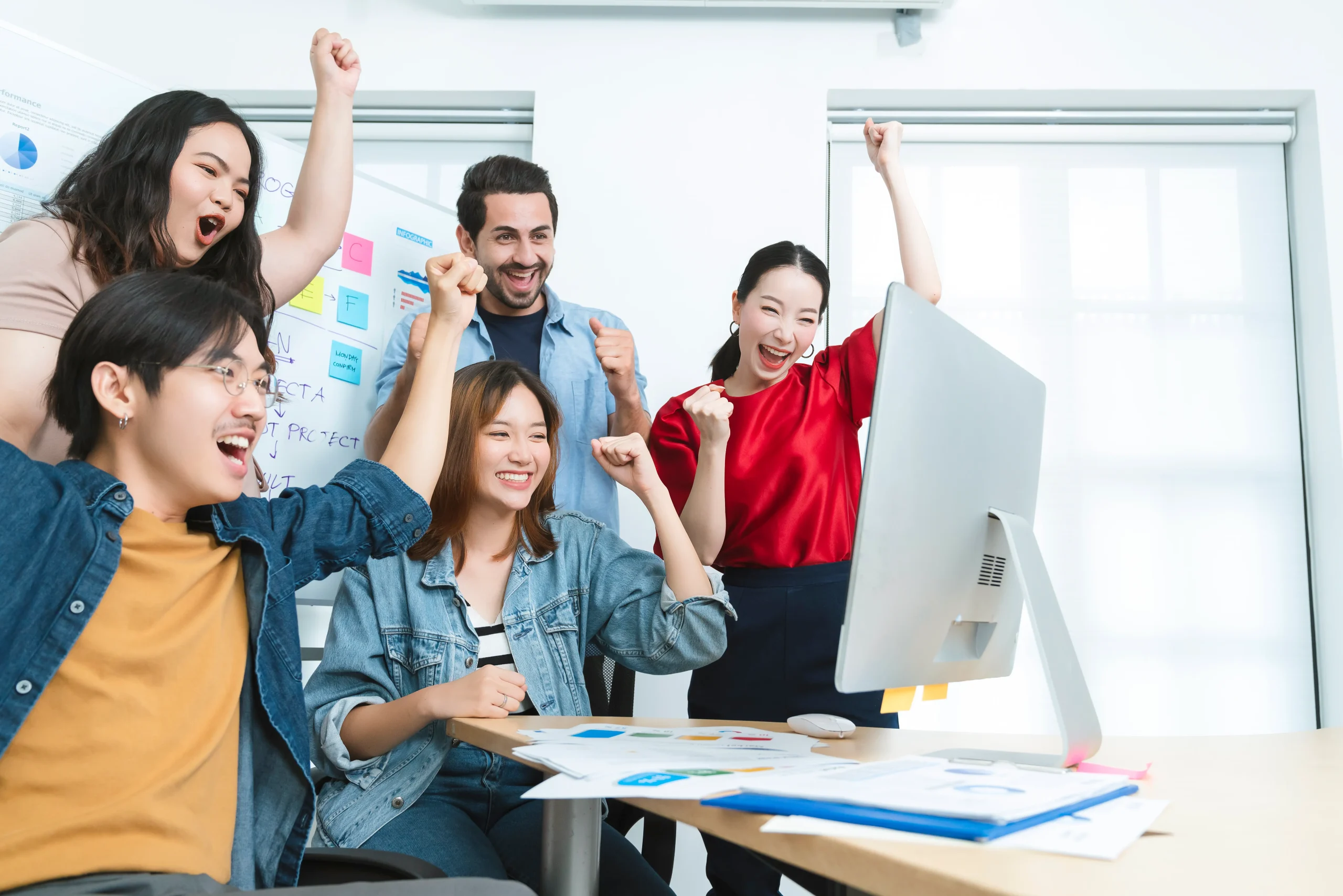 Group celebrating success in office